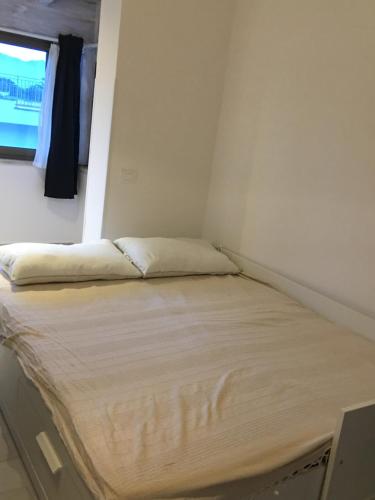 a bed in a small room with a window at Sofia Mare in San Felice Circeo