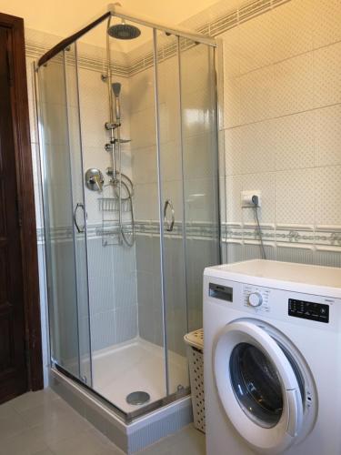 a washing machine in a bathroom with a shower at Sofia Mare in San Felice Circeo