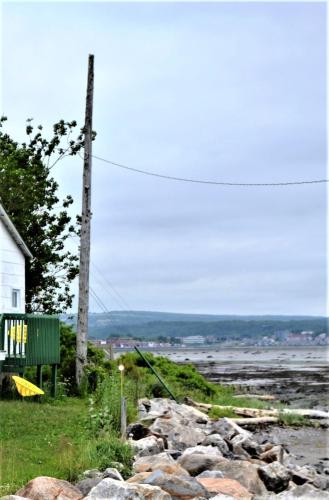 a pile of rocks in front of a house at Motel Rimouski in Rimouski