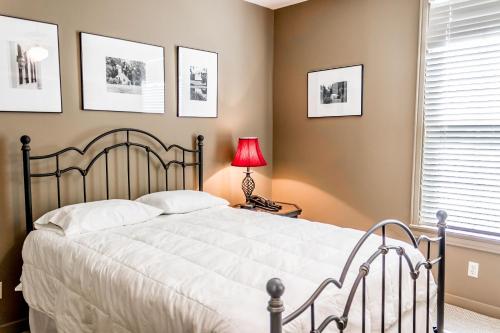 a bedroom with a bed and a red lamp at The Lodge at The Bluffs in Saint Francisville