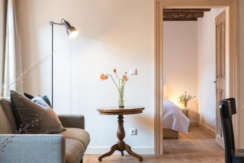a living room with a table and a lamp at Palais Wunderlich in Lahr