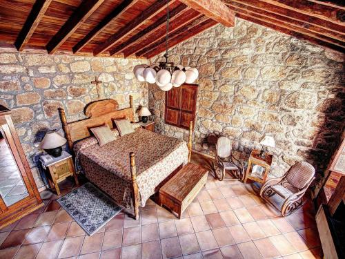 
a room with a bed, a chair, a table and a window at Hotel Rural San Miguel - Only Adults in San Miguel de Abona
