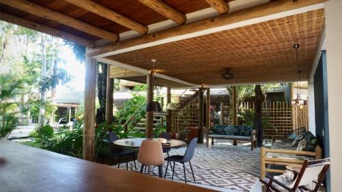 an open patio with a table and chairs on it at Soleluna Casa Pousada in Trancoso