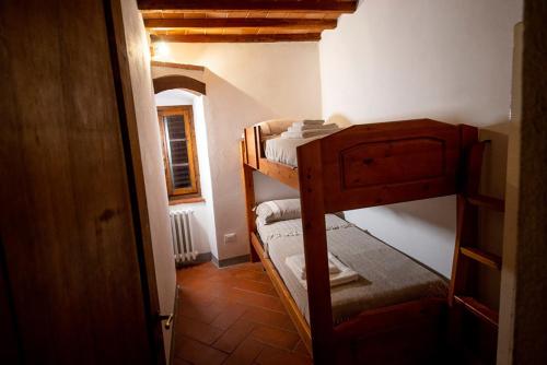a small room with two bunk beds in a house at Il Papavero - Montefioralle Apartment in Greve in Chianti