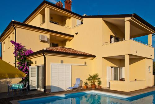a house with a swimming pool in front of it at Vila Bicikleta Istra in Peroj