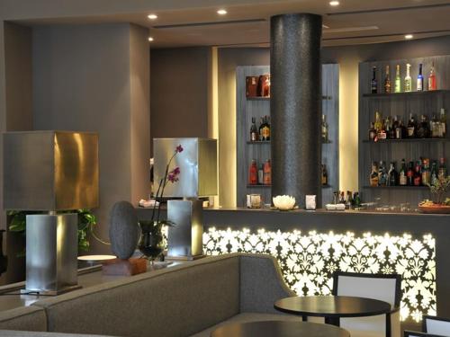 a bar in a restaurant with lights on the wall at Grand Hotel Villa Itria Congress & Spa in Viagrande