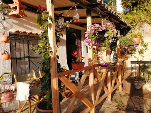 a porch with a bunch of flowers on it at El Pedregal Sopó in Sopó