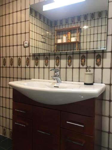a bathroom with a white sink and a mirror at BIESCAS-PIRINEO-RELAX in Biescas