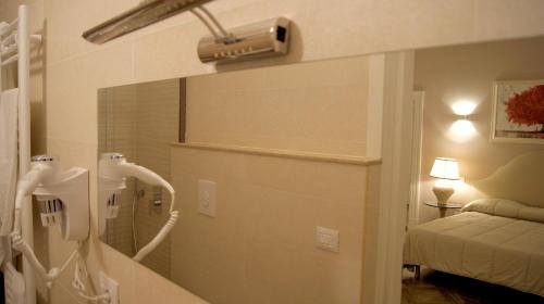 a bathroom with a shower and a bed in a room at La Maison in Taranto
