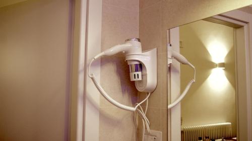 a hair dryer is attached to a bathroom mirror at La Maison in Taranto