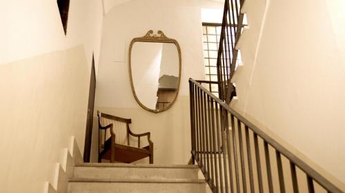 a stairway with a mirror on the wall at La Maison in Taranto