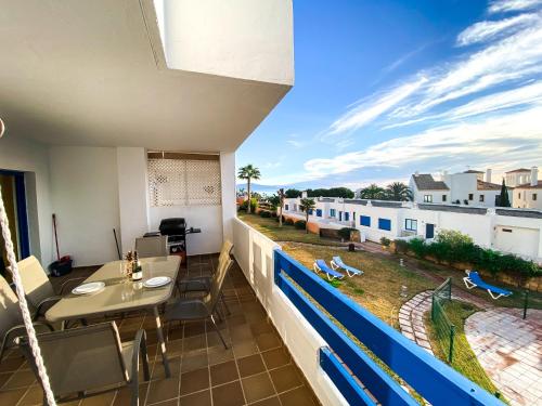 a balcony with a table and chairs and a view at Beautiful New Apartment with Sea View in Castillo de Sabinillas