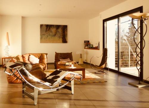a living room with a couch and a table at Le Castellas du Pic St Loup in Saint-Mathieu-de-Tréviers