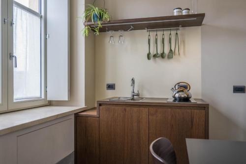 a kitchen with a sink and a counter with utensils at CABANON urban apartments in Peschiera del Garda