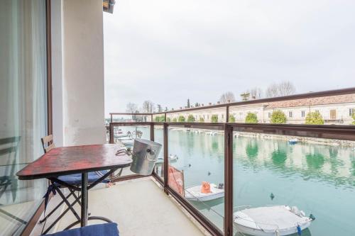 a balcony with a view of a body of water at CABANON urban apartments in Peschiera del Garda