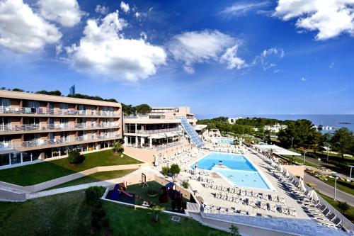 a hotel with a swimming pool and a resort at Hotel Molindrio Plava Laguna in Poreč