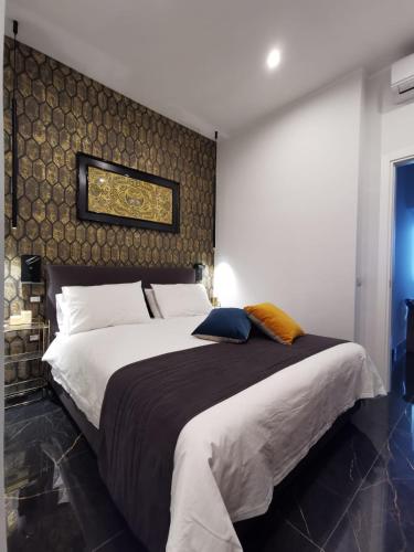 a bedroom with a large bed with a wall at Vomero Guest House in Naples