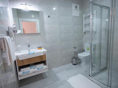 a bathroom with a shower and a sink and a toilet at acar hotel Kırıkkale in Kırıkkale