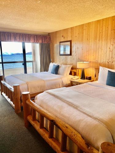 a hotel room with two beds and a window at Tahoe Lakeshore Lodge & Spa in South Lake Tahoe