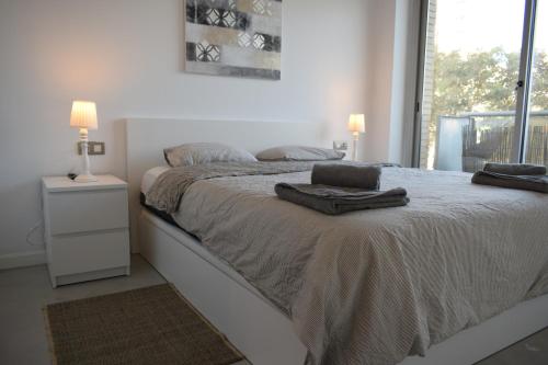 a bedroom with a bed with two pillows on it at Magnificent apartment close to the beach in Barcelona