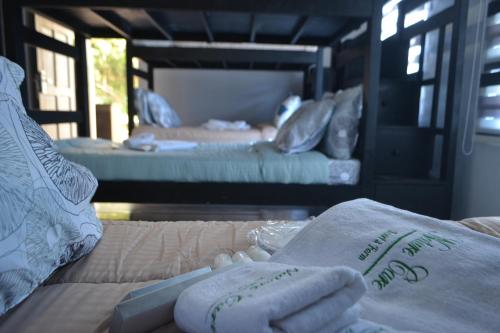 a room with two beds and towels on a couch at Nature Care Resort and Farm in Pulilan