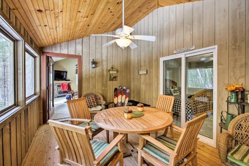 a dining room with a table and chairs and a ceiling fan at North Conway Retreat - 1 Mi to Cranmore Mountain! in North Conway