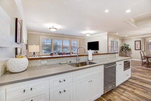 a kitchen with white cabinets and a sink at Sonoma Bungalows in Sonoma