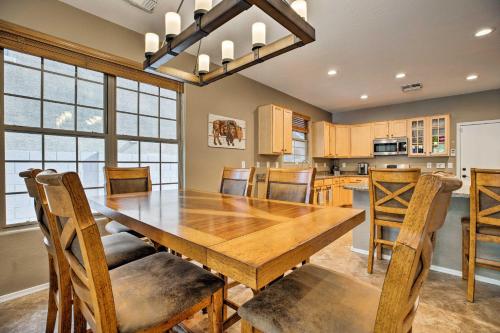 a kitchen and dining room with a wooden table and chairs at Family Home with Pool, BBQ and Fire Pit in Goodyear in Goodyear