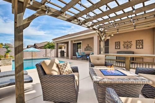 a patio with a table and chairs and a pool at Family Home with Pool, BBQ and Fire Pit in Goodyear in Goodyear