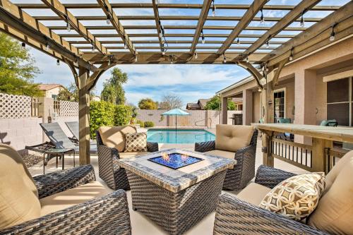 a patio with a table and chairs and a pool at Family Home with Pool, BBQ and Fire Pit in Goodyear in Goodyear