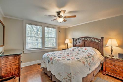a bedroom with a bed and a ceiling fan at Cheery Cottage with Yard Less Than 1 Mile to Marietta Square in Marietta