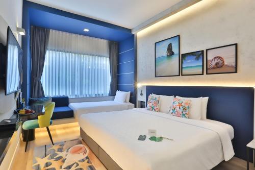 Ένα ή περισσότερα κρεβάτια σε δωμάτιο στο Hotel Clover Patong Phuket - SHA Plus
