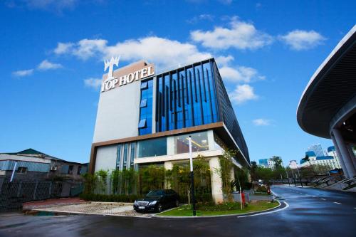 a building with a car parked in front of it at Friendship hotel in Hanoi