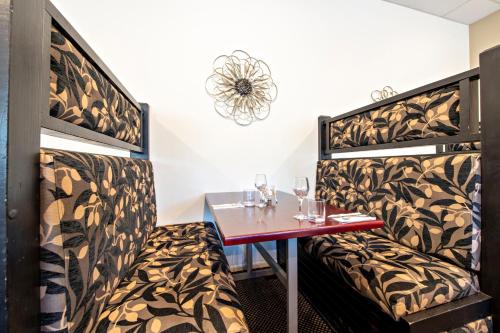 a dining room with a table and wine glasses at Matilda Motor Inn in Dubbo
