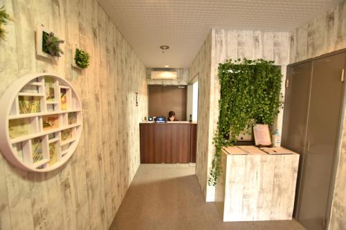 an office with a green wall and a hallway at Randor Residence Tokyo Classic in Tokyo
