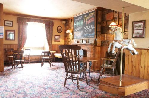 a room with chairs and a table and a chalkboard at Radstock Hotel near Bath in Radstock