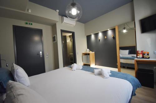 a bedroom with a large white bed in a room at Be My Guest Athens in Athens