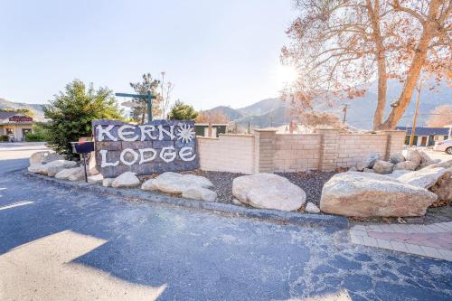 a sign that says kenny lodge on the side of a road at The Kern Lodge in Kernville