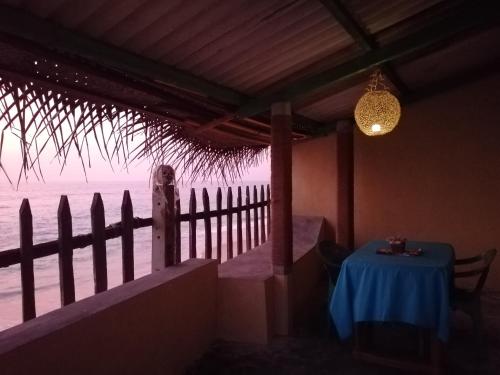 a table in a room with a view of the ocean at The Madampa Sea Side Lodge in Ambalangoda