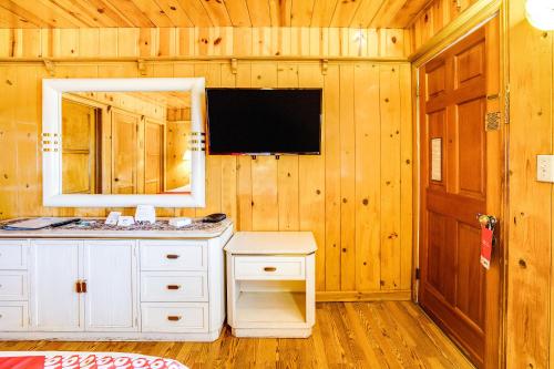 a bathroom with a white vanity and a mirror at The Kern Lodge in Kernville