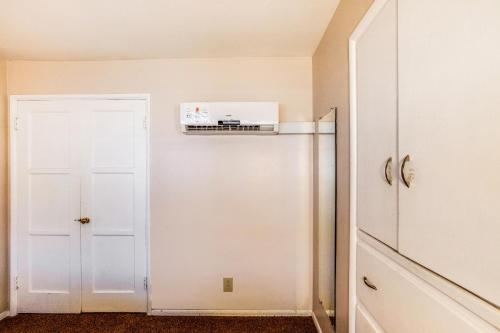 a white refrigerator in a room with a door at The Kern Lodge in Kernville