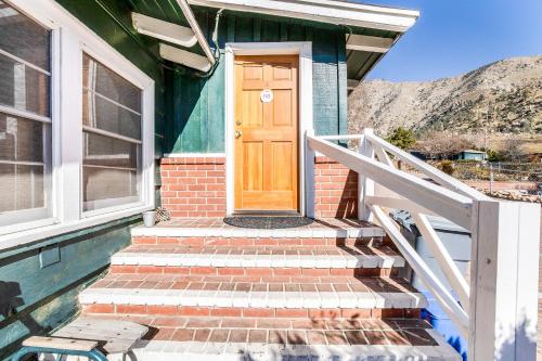 a wooden door on a house with stairs at The Kern Lodge in Kernville