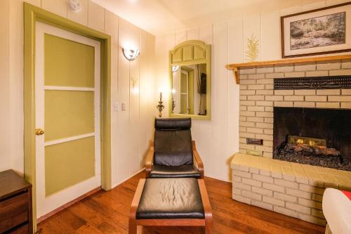 a living room with a chair and a fireplace at The Kern Lodge in Kernville