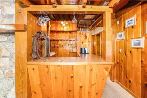 a bar in a wooden room with wooden walls at The Kern Lodge in Kernville