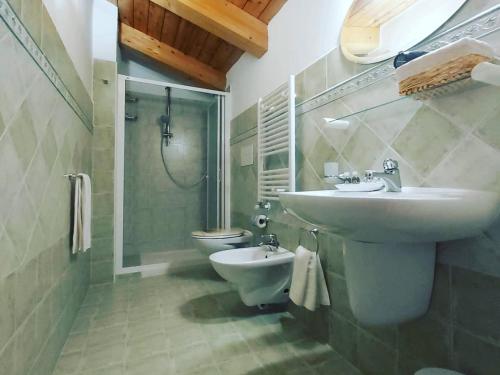 a bathroom with a sink and a toilet and a shower at Al Vecchio Corso B&B in Tempio Pausania