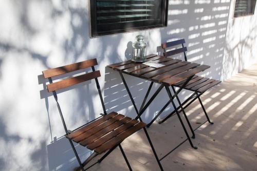 a table and two chairs sitting on a porch at Hotel Flora and Fauna in Wimberley