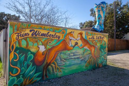 a mural on a wall with two foxes at Hotel Flora and Fauna in Wimberley