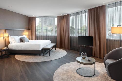 a hotel room with a bed and a couch at Hotel Victoria in Basel