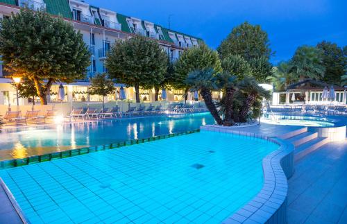 a swimming pool in a hotel at night at Hotel Paris Resort in Bellaria-Igea Marina