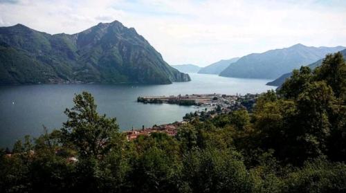 a town in the middle of a lake with mountains at Casa Tiziana in Sovere